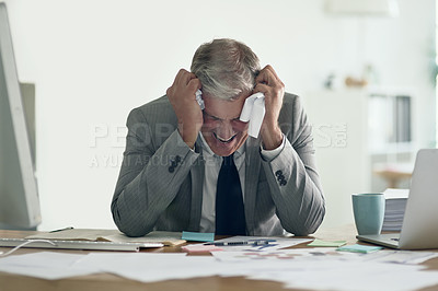 Buy stock photo Shot of a frustrated businessman crumpling up paperwork while sitting at his desk
