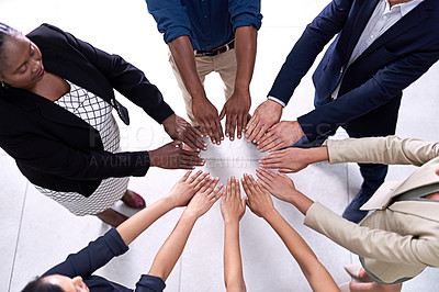 Buy stock photo High angle shot of a group of unidentifiable businesspeople making a circle with their hands in the office