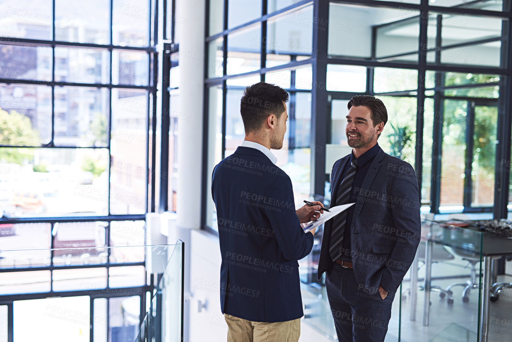 Buy stock photo Cropped shot of two businessmen having a discussion in an office