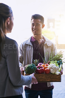 Buy stock photo Cropped shot of a courier making a grocery delivery to a customer