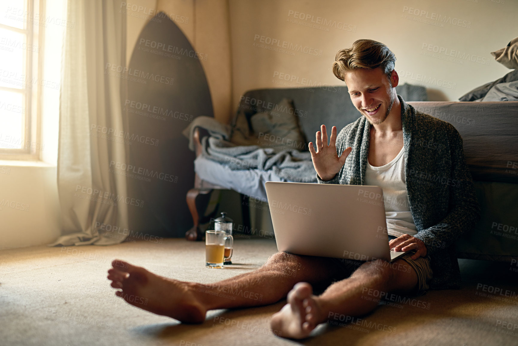 Buy stock photo Video call, wave and man on laptop on floor for conversation, online chat and hello for greeting. Communication, social networking and person on computer for discussion, talking and speaking in home