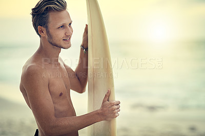Buy stock photo Shot of a shirtless young surfer watching the waves while holding his surfboard at the beach