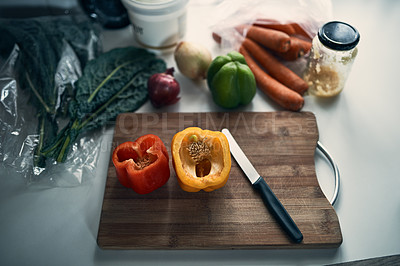 Buy stock photo High angle shot of chopped peppers on a cutting board surround by various vegetables on a kitchen counter