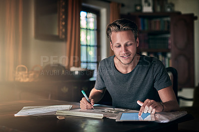 Buy stock photo College homework, studying and a man with a tablet for research, education and elearning. Smile, working and a male student with technology for information and planning for an exam in a house