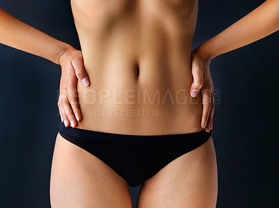 Buy stock photo Cropped shot of a beautiful young woman posing against a dark background