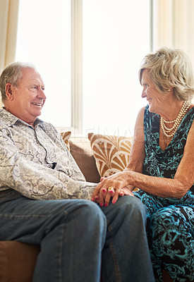 Buy stock photo Shot of a happy senior couple relaxing on the sofa together at home