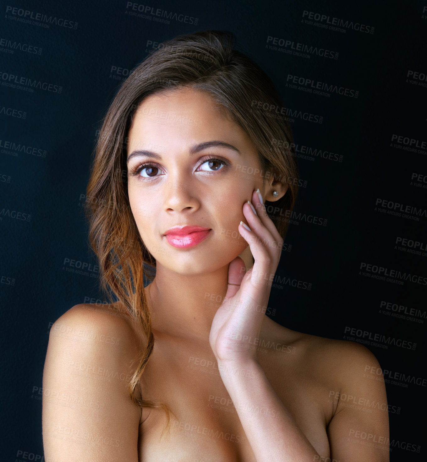 Buy stock photo Portrait of a beautiful young woman posing against a dark background