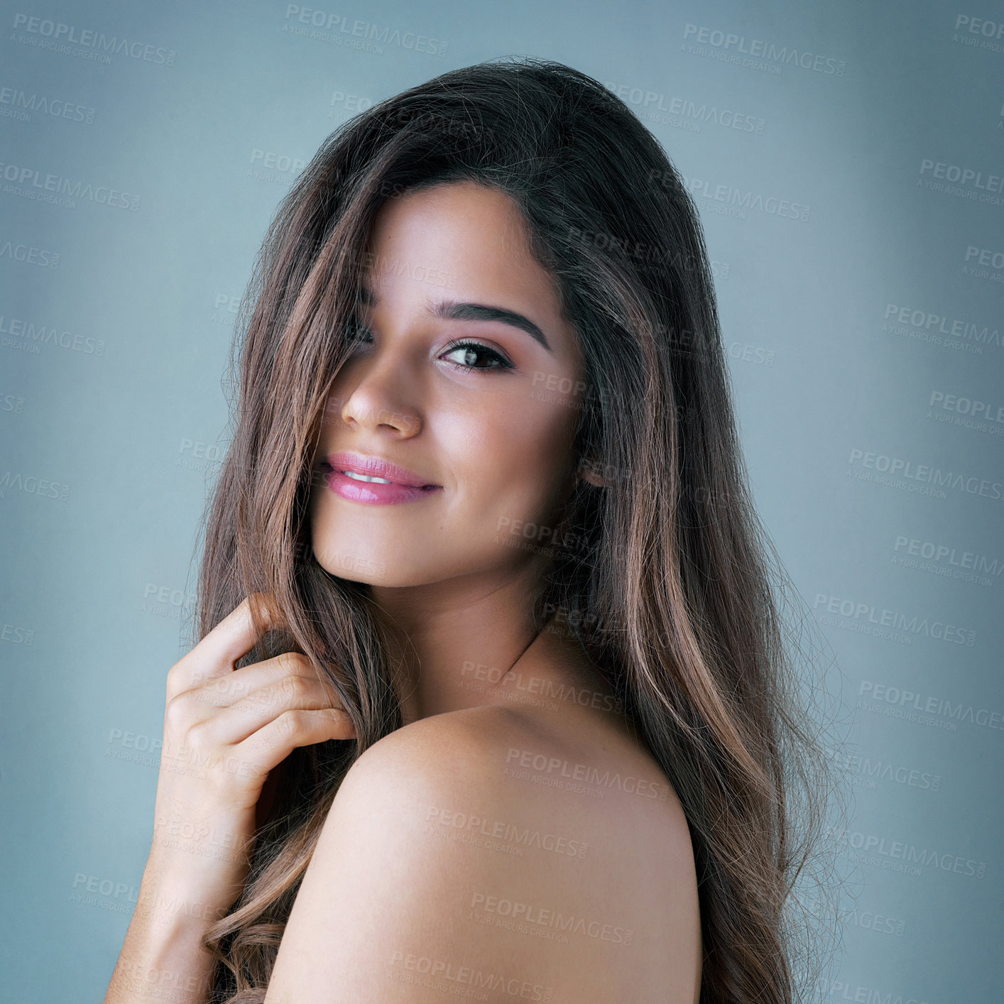 Buy stock photo Studio shot of a beautiful young woman posing against a gray background