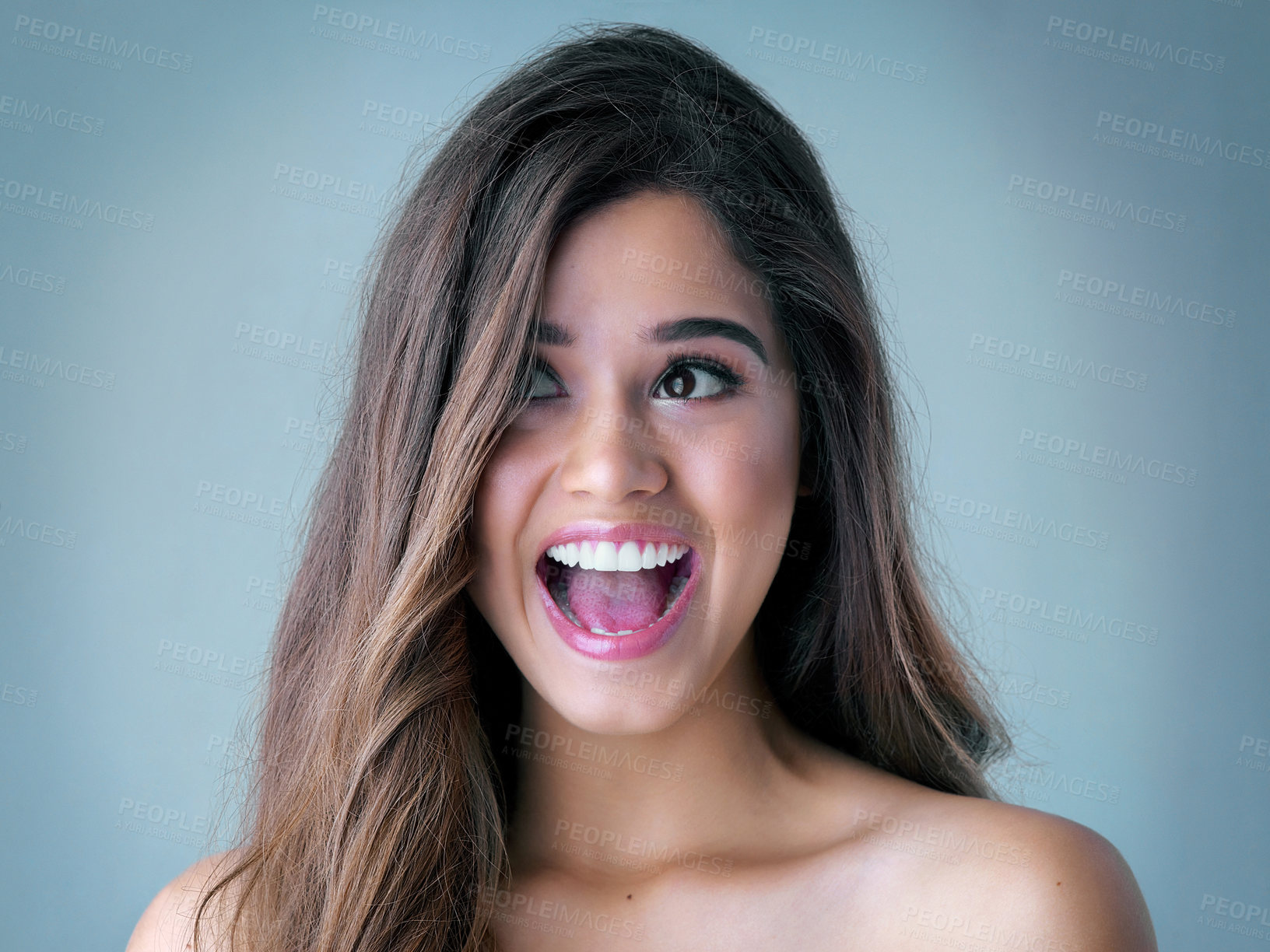 Buy stock photo Happy woman, surprise and beauty with makeup for offer, deal or crazy haircare on a blue studio background. Excited, attractive female person or young model with cosmetics in wow for glow up or shine