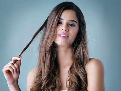 Buy stock photo Hair care, woman and portrait in studio for beauty with healthy texture, salon treatment or shampoo shine. Person, face and makeup with cosmetics wellness, growth progress or happy on blue background