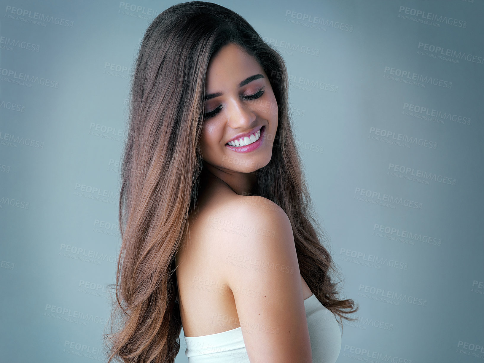 Buy stock photo Smile, relax and woman in studio with hair care, cosmetic results and luxury shampoo treatment. Benefits, texture and happy girl with fun hairstyle, keratin therapy and confidence on blue background