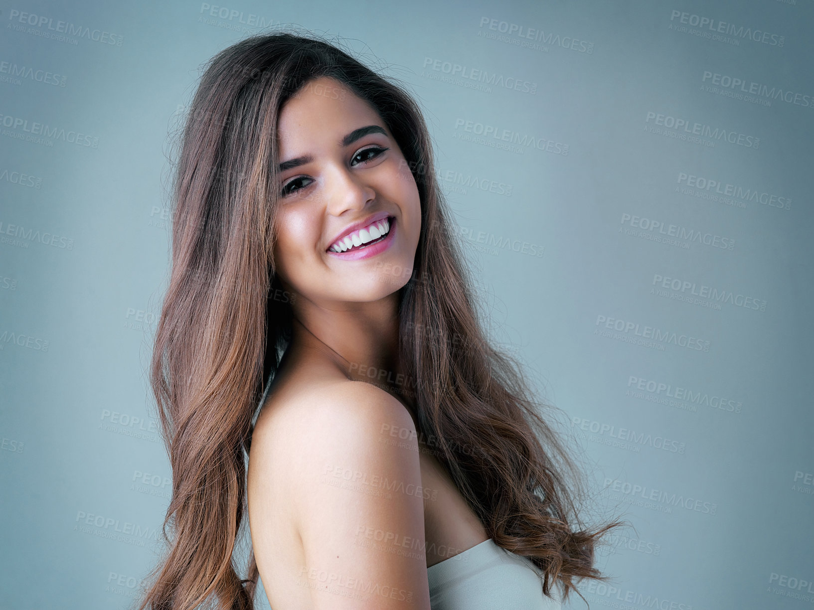 Buy stock photo Portrait, confidence and happy woman in studio with hair care, cosmetic results or luxury shampoo treatment. Smile, texture and girl with trendy hairstyle, keratin therapy and blue background mockup