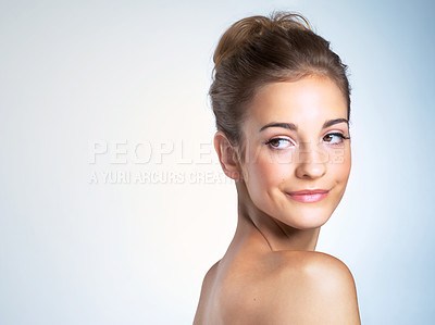 Buy stock photo Studio shot of a beautiful young woman looking over shoulder