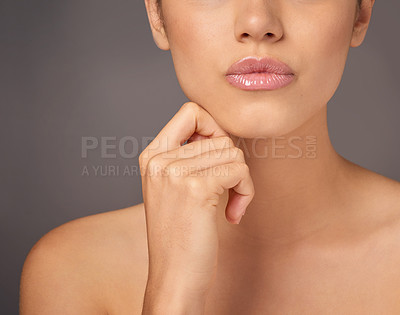 Buy stock photo Closeup studio shot of a woman with gorgeous glossy lips against a gray background