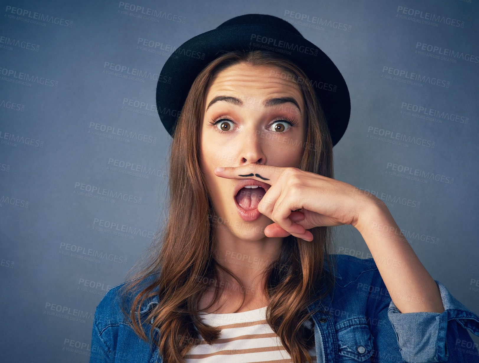 Buy stock photo Girl, finger and mustache in studio with portrait for quirky behavior, facial expression and funny face with hat. Wow, silly and hand gesture for creative humor, goofy and playful on dark background.