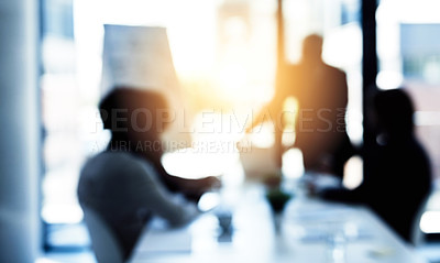 Buy stock photo Shot of a group of business colleagues talking together during a meeting in a boardroom