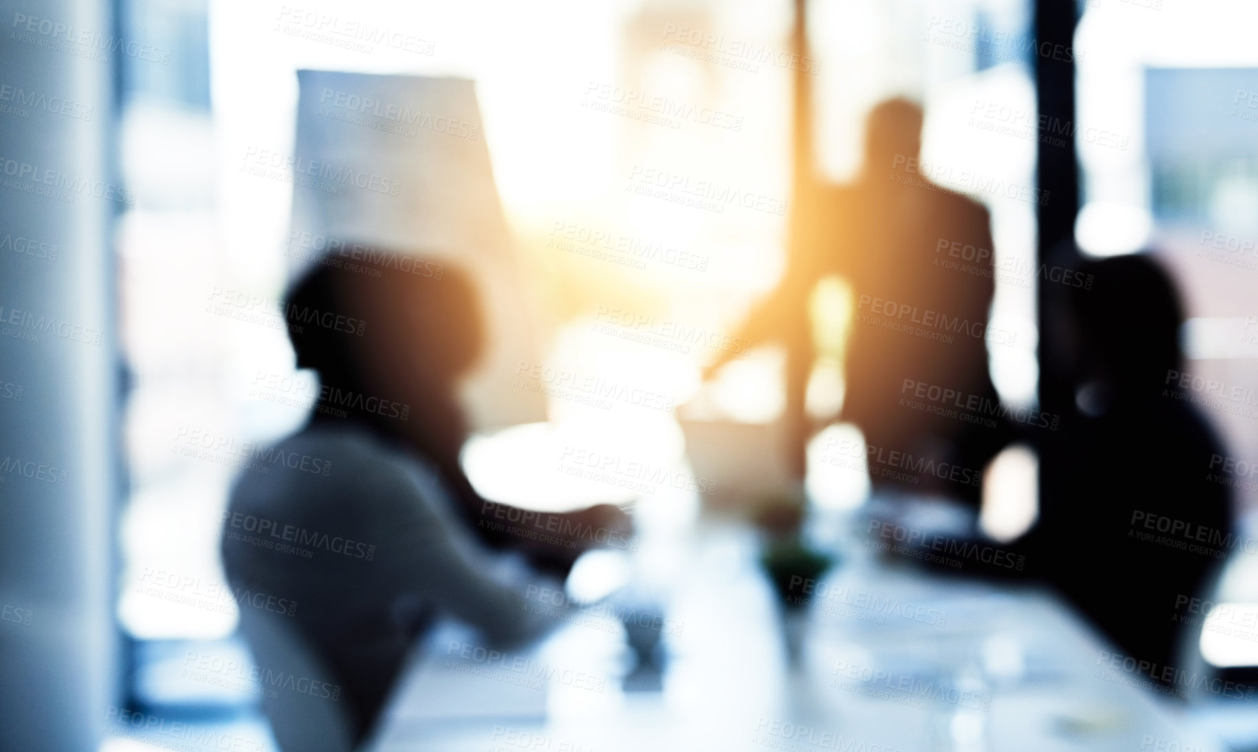 Buy stock photo Shot of a group of business colleagues talking together during a meeting in a boardroom