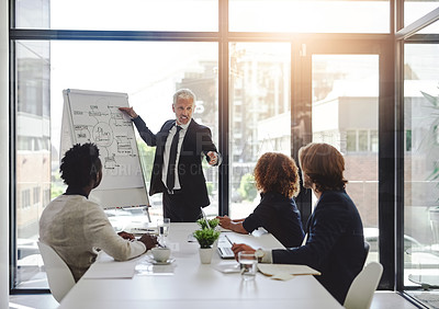 Buy stock photo Cropped shot of a businessman giving a presentation to his colleagues in a boardroom