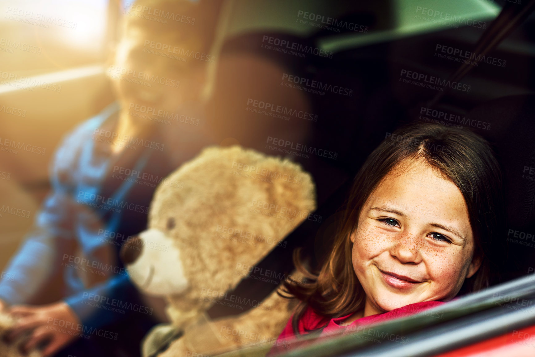 Buy stock photo Young girl, portrait and road trip for travel, childhood and family holiday with smile and teddy bear. Children, happy and adventure in car for journey, driving and vacation by window in summer