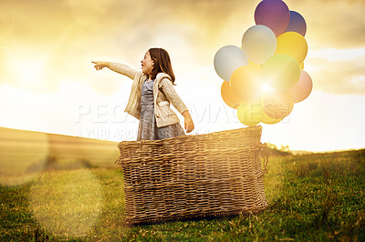 Buy stock photo Shot of cute little girl playing outside with a basket and a bunch of balloons