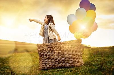 Buy stock photo Balloon, basket and girl with adventure in nature for imagination, creativity and explore together. Field, kid and invention with point at sunset for fantasy travel direction, location and childhood