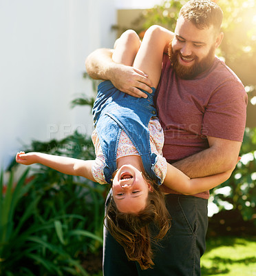Buy stock photo Shot of an adorable little girl having fun with her father in their backyard