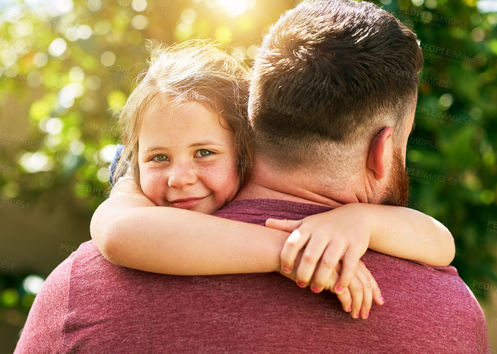 Buy stock photo Shot of an adorable little girl giving her father a hug outdoors