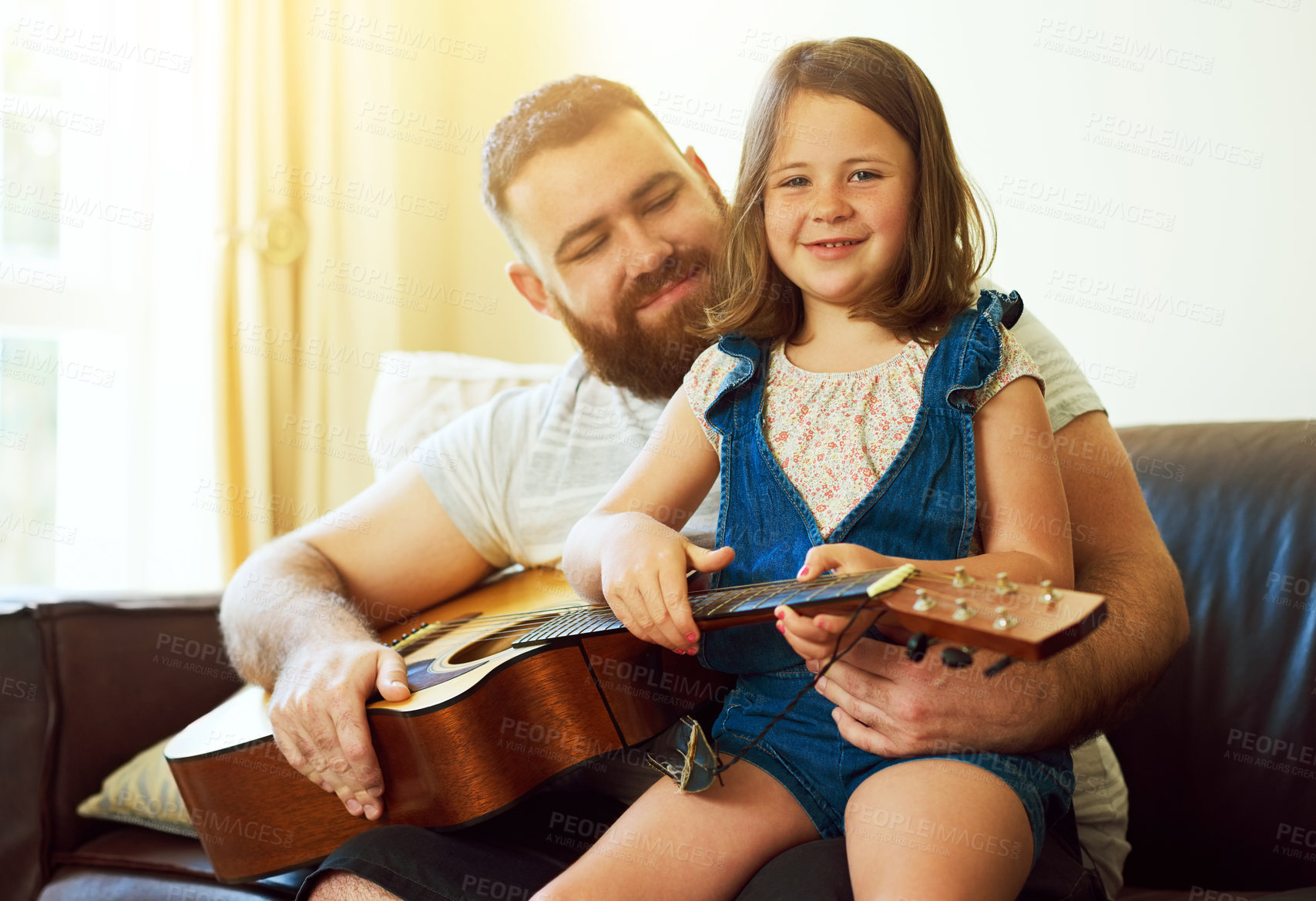 Buy stock photo Father, home and girl with guitar on sofa, learning music and family bonding or teaching instrument in house. Weekend, childhood development and creative for knowledge, growth and playing together