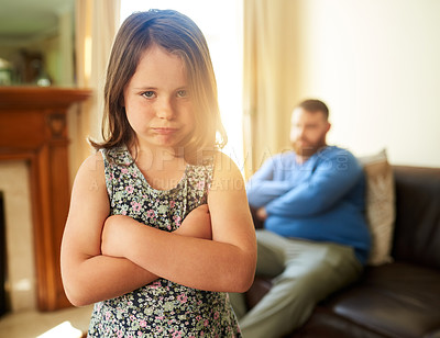 Buy stock photo Shot of an unhappy little girl sulking after a disagreement with her father