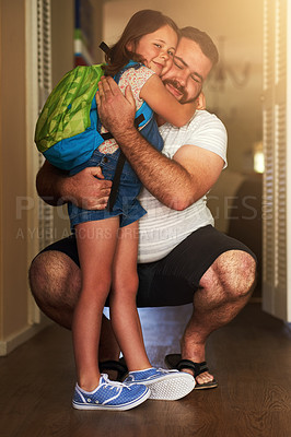 Buy stock photo Shot of an adorable little girl hugging her father after coming home from school