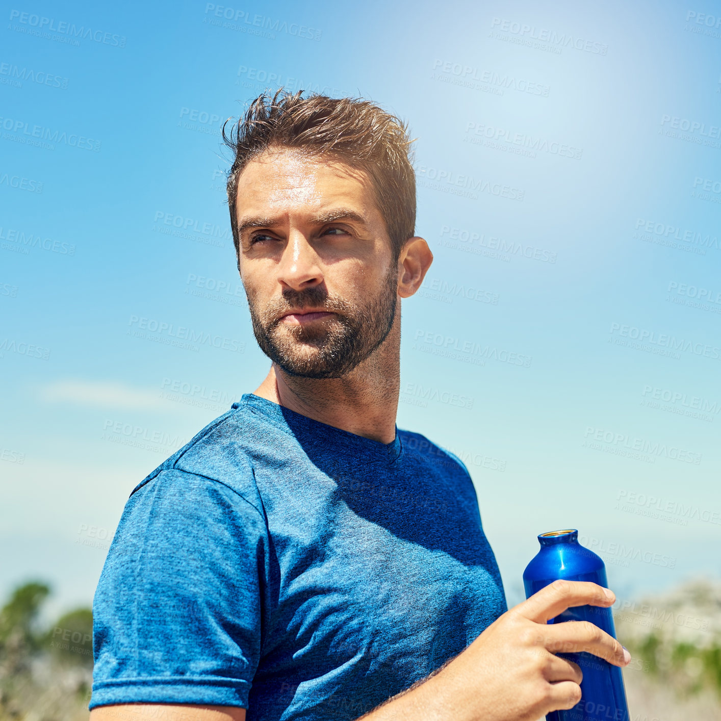 Buy stock photo Cropped shot of a young man taking a break while out for a run