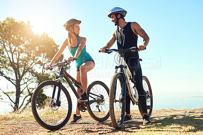 Buy stock photo Couple, morning cardio and cycling in the mountains for fitness and exercise together. Bike, wellness and young people with outdoor adventure and sports training with happiness and freedom in sun