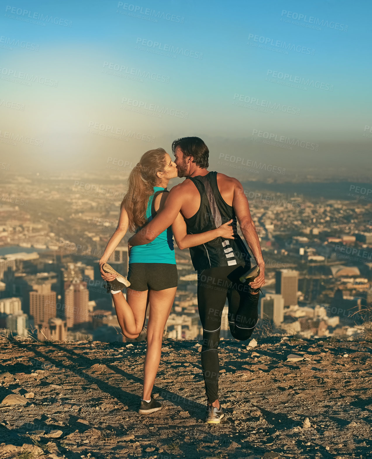 Buy stock photo Shot of a loving couple out stretching before their workout