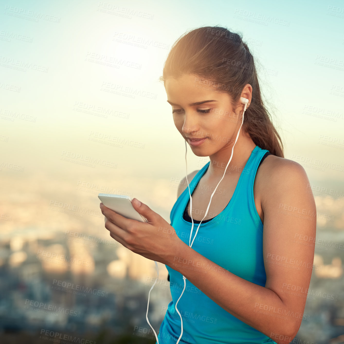 Buy stock photo Fitness, girl and smartphone in outdoor for music with exercise, motivation and earphones for training routine with streaming audio. Woman, online and internet for coaching podcast and audiobooks.