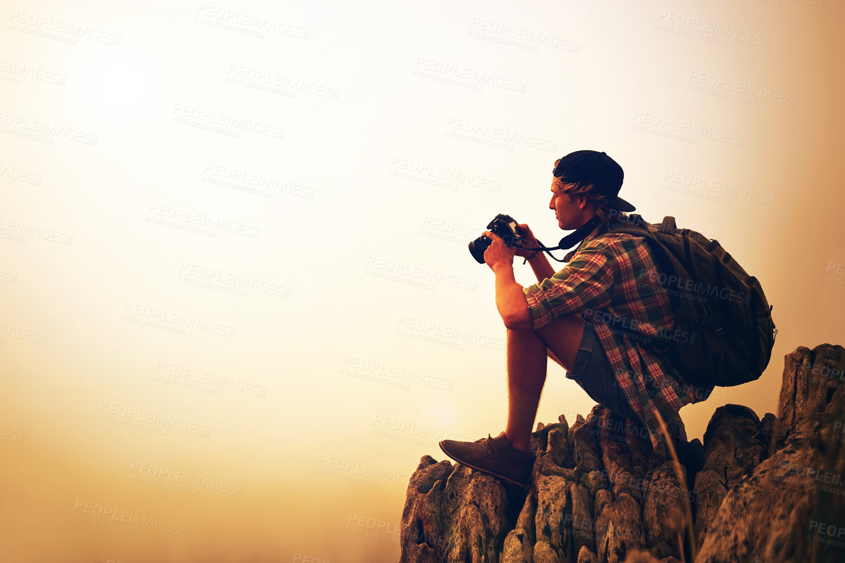 Buy stock photo Sunset, nature photographer and man on mountain for picture on holiday, vacation and mockup space. Camera, photography and person at cliff outdoor for hiking, adventure and travel with view of fog