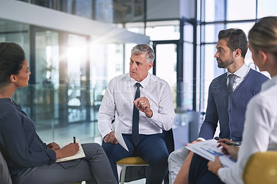 Buy stock photo Cropped shot of a group of businesspeople having a discussion in an office