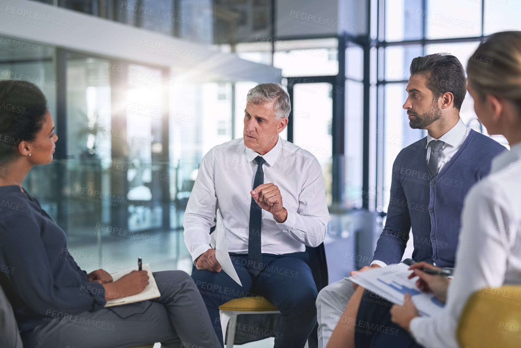 Buy stock photo Cropped shot of a group of businesspeople having a discussion in an office