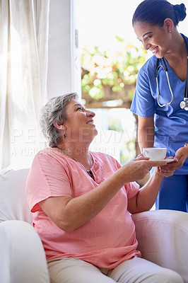 Buy stock photo Cropped shot of a caregiver offering a cup of tea to a senior patient in a nursing home
