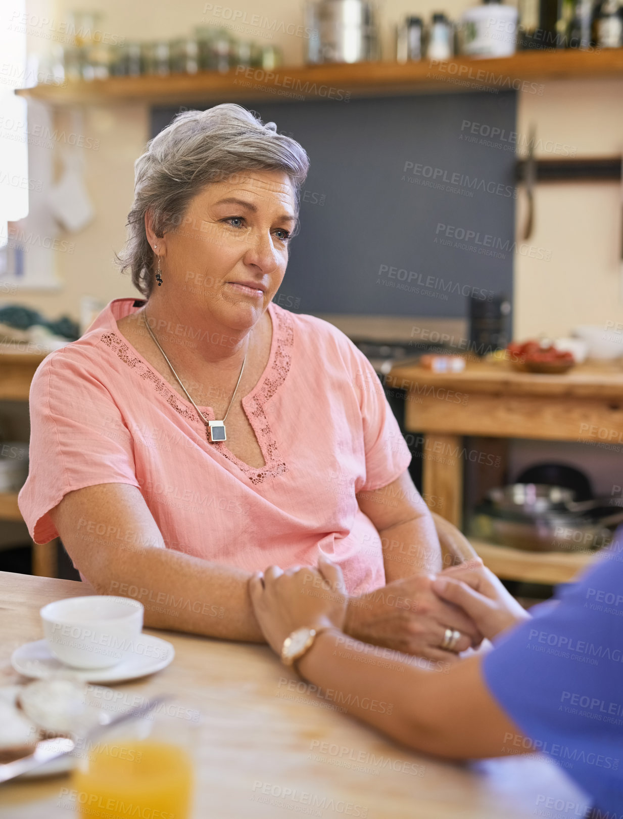 Buy stock photo Therapy, holding hands and senior woman in kitchen for advice, kindness and mental health. Tea, service and medical worker or caregiver with retired female person in home for conversation and support