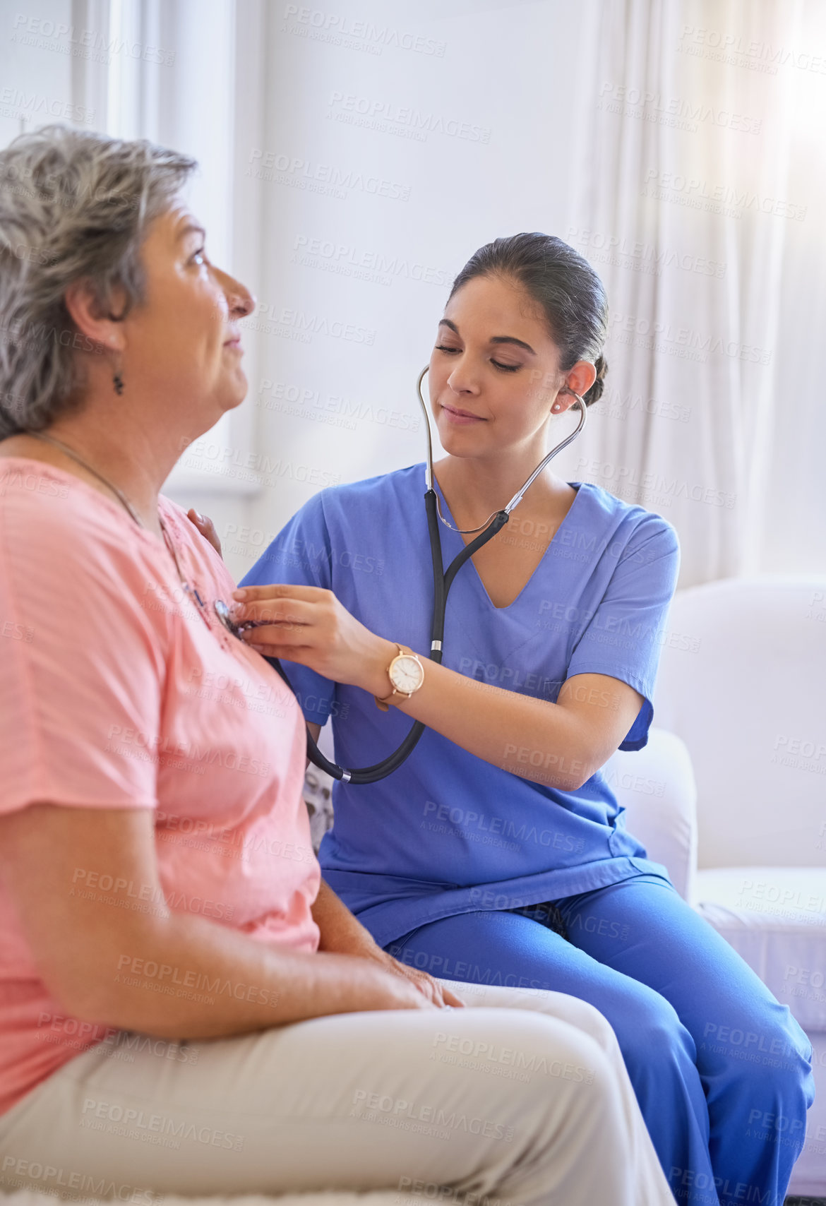 Buy stock photo Cropped shot of a nurse examining a senior patient with a stethoscope