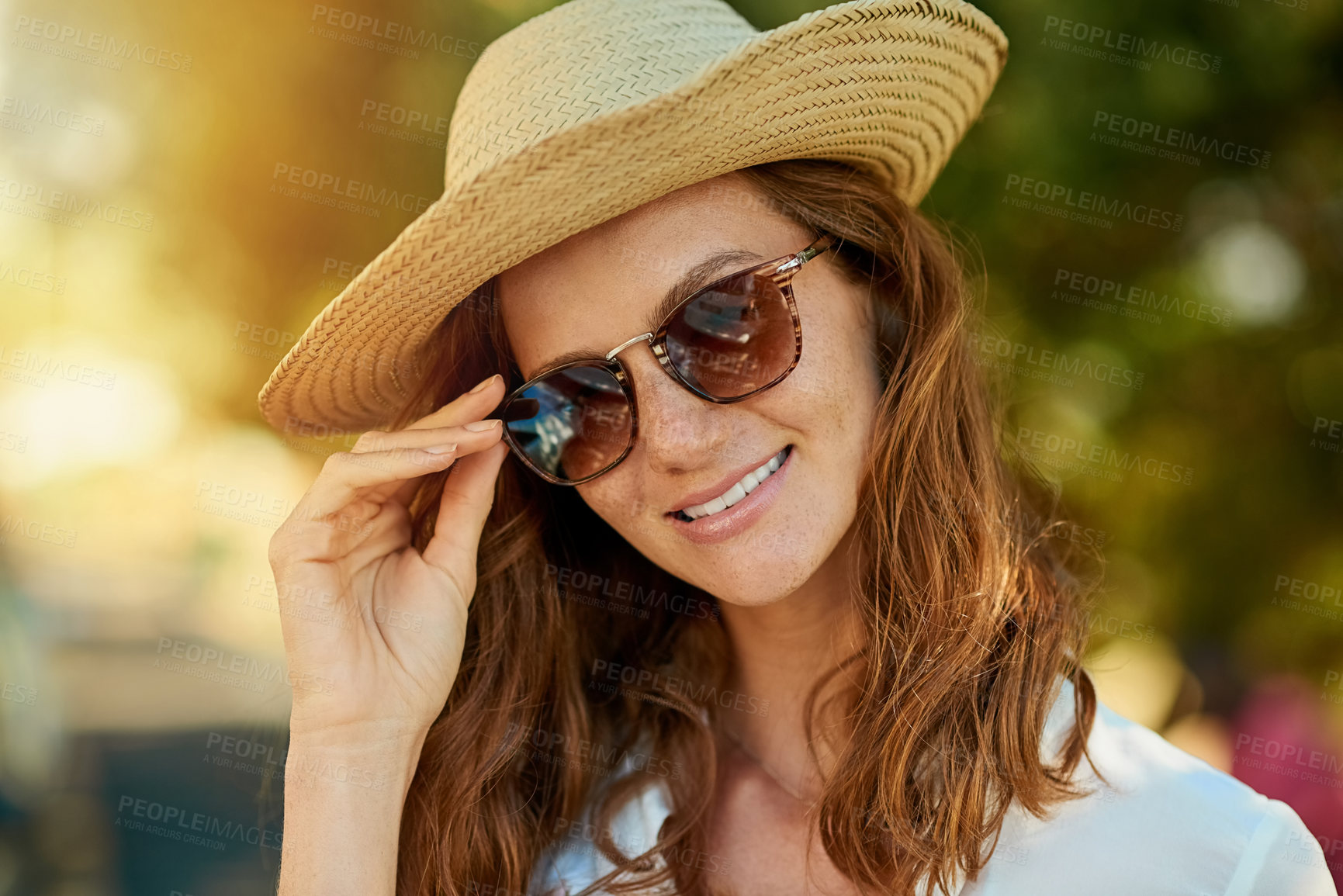 Buy stock photo Shot of an attractive young woman enjoying a summer’s day outdoors