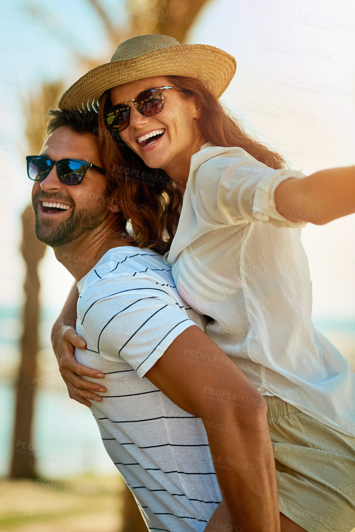 Buy stock photo Couple, people and sunglasses on piggyback in outdoor with smile for summer holiday and fun in Spain. Relationship, love and happy with support on vacation, trip and travel together as soulmate