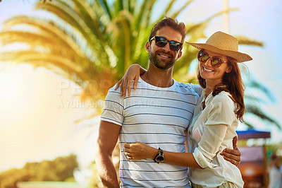 Buy stock photo Shot of an affectionate young couple enjoying a summer’s day outdoors
