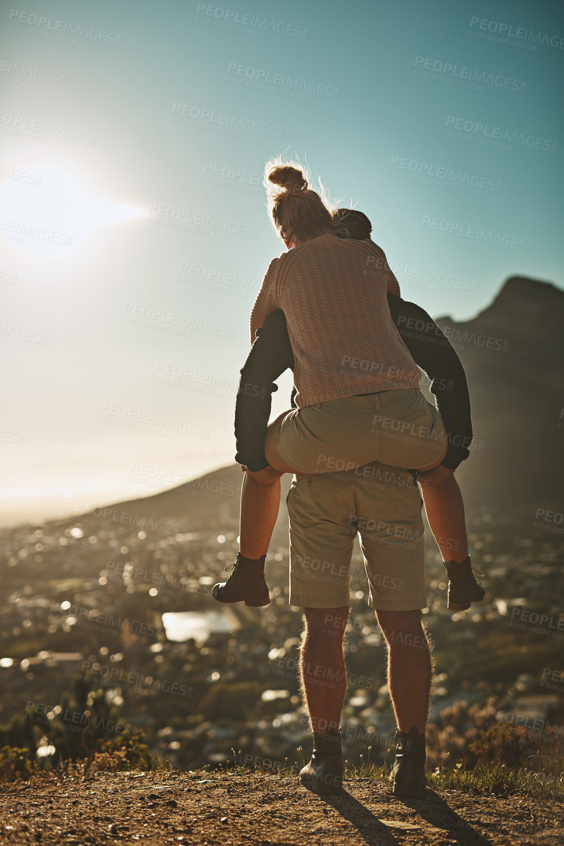 Buy stock photo Piggy back, couple and adventure on mountain for hiking, love and sunset with cityscape. Man, woman and together in nature for trekking, travel and support or date for summer or holiday in California