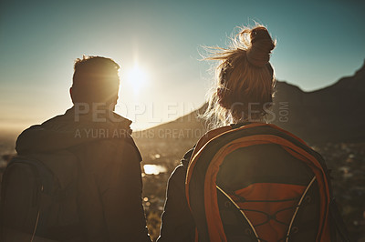 Buy stock photo Rearview shot of a couple admiring the view from a mountain top