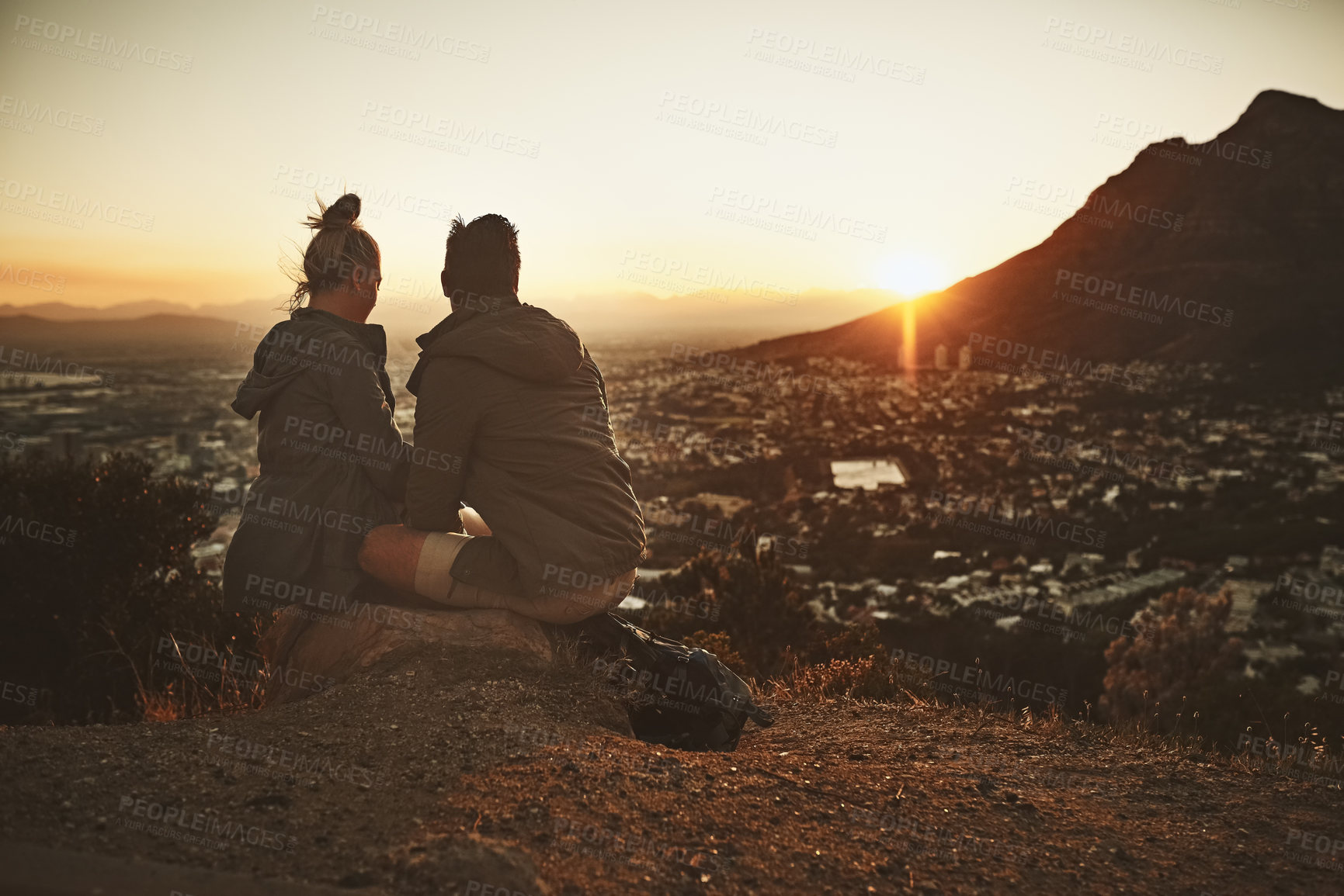 Buy stock photo Couple, hiking and sunrise on mountain with relax for morning adventure, scenery and explore with bonding. Back, people and trekking on expedition for sightseeing, love or together on cliff in nature