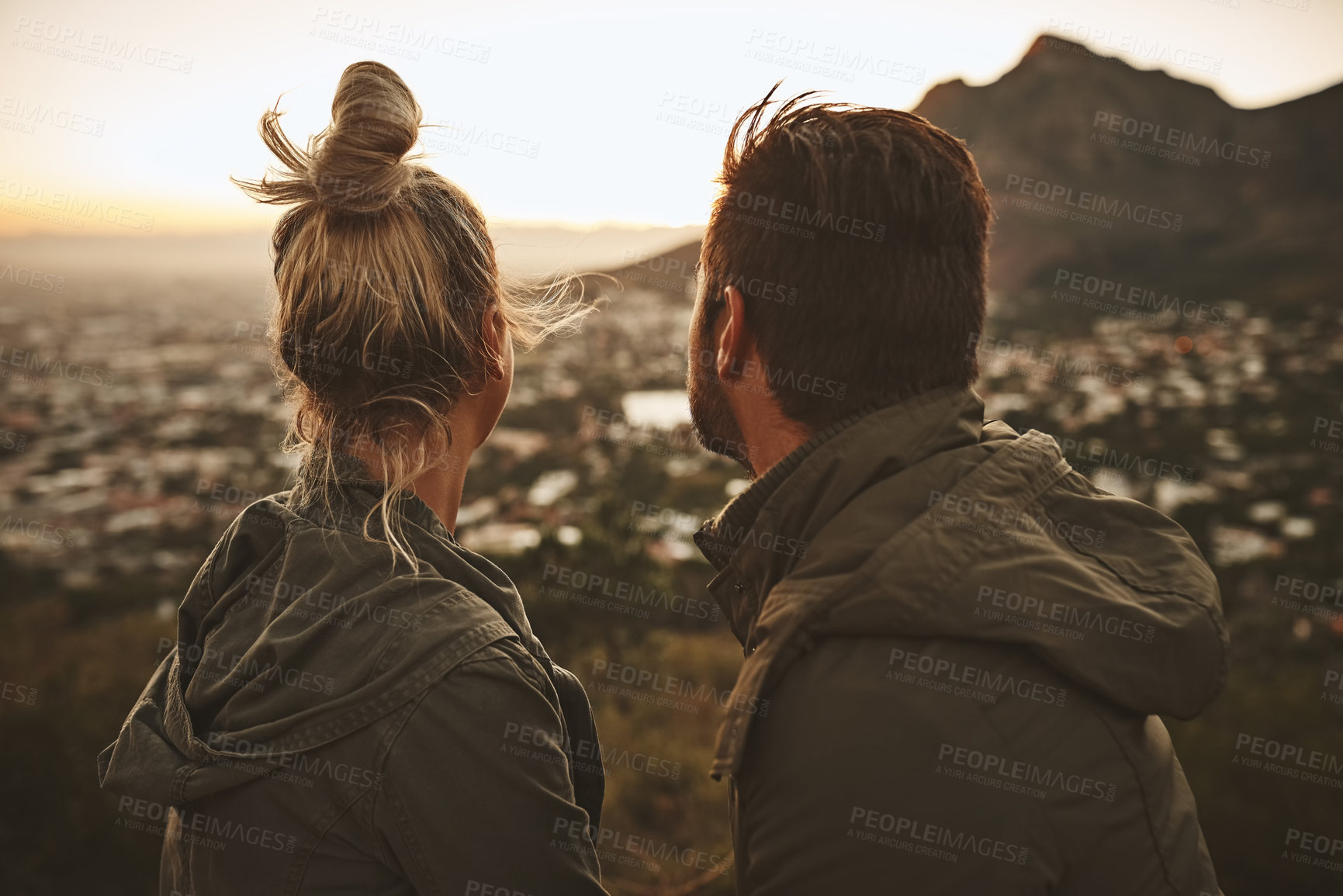 Buy stock photo Couple, hiking and scenery of sunrise on mountain for morning adventure, view and explore with bonding. Back, people and trekking on expedition for sightseeing, relax and together on cliff in nature