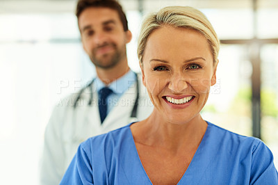 Buy stock photo Portrait of two happy healthcare practitioners posing together in a hospital