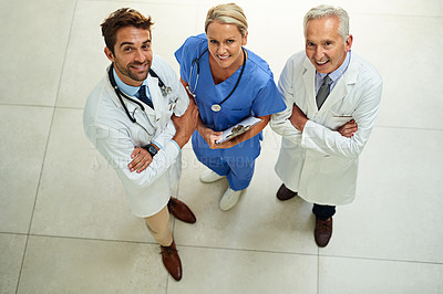 Buy stock photo High angle portrait of three happy healthcare practitioners posing together in a hospital