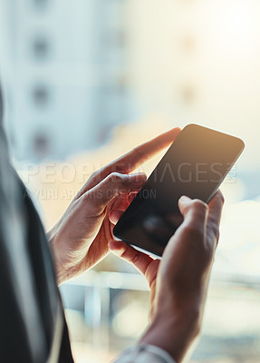 Buy stock photo Shot of an unrecognizable young businesswoman using her cellphone in the office